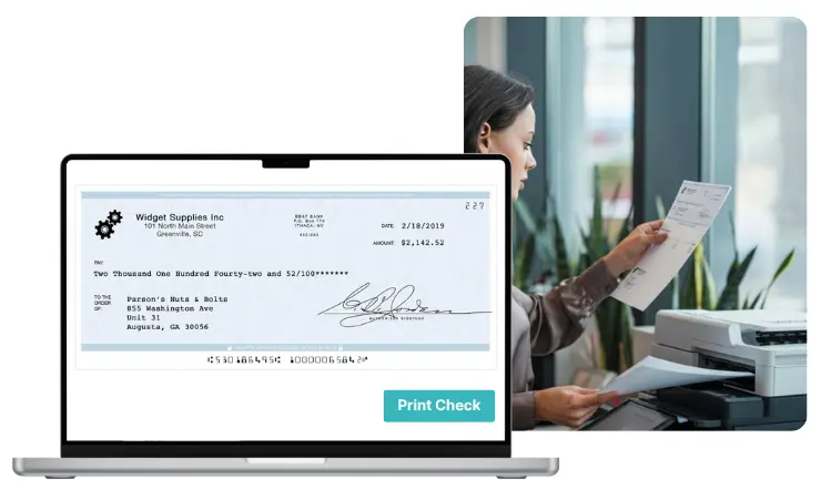 Laptop Screen Displays a Digital Check for $2,142.52, While a Woman Prints a Check from a Printer in a Modern Office Setting