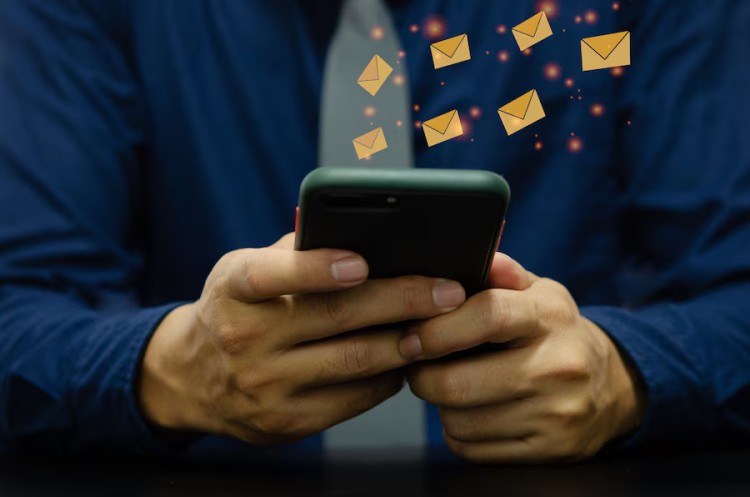 A Person Holding a Smartphone with Animated Email Icons Representing Check Mailing and Emailing