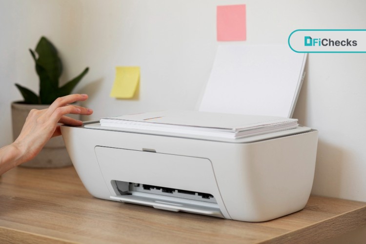 A Person Using a White Printer with Stacked Checks, Highlighting the Ability to Print Checks Conveniently