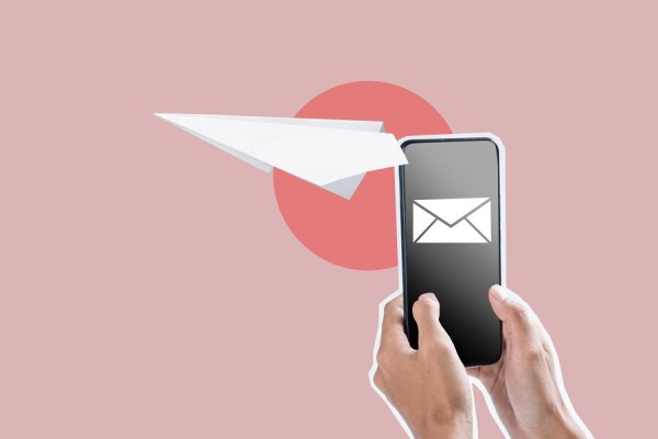 Secure Digital Check Emailing & Mailing Options A Pair of Hands Holding a Smartphone with an Email Icon, While a Paper Airplane Symbolizes Digital Check Delivery