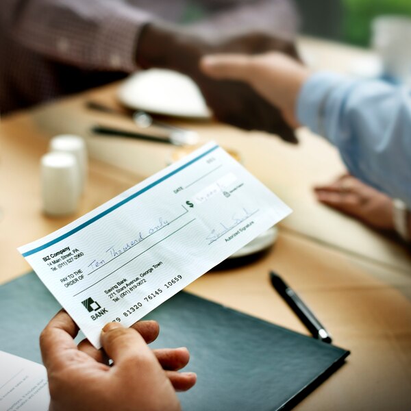 A Person Using FiChecks on a Mobile Device to Manage Check Payments Conveniently from Anywhere