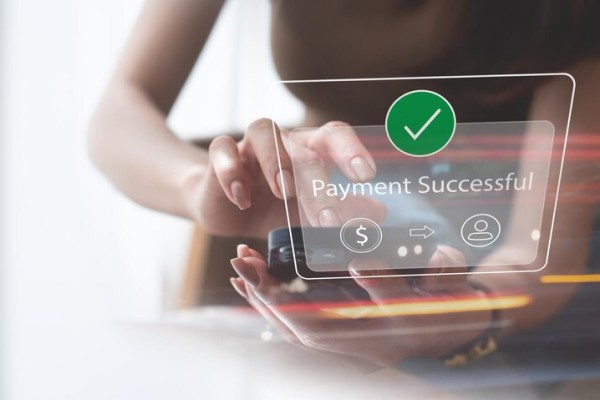 Woman Using Smartphone with Digital Overlay Showing “Payment Successful” and Icons