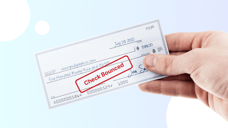 Hand Holding a Check Dated July 29, 2010, for $599.00 with a Red "Check Bounced" Stamp Across It